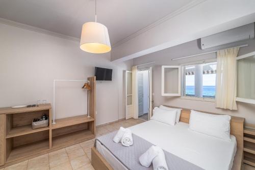 a bedroom with a large bed and a mirror at Monato Luxury Apartments in Agios Nikitas