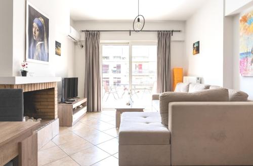 a living room with a couch and a fireplace at "Athena 3" luxury's apartments in Athens !!! in Athens