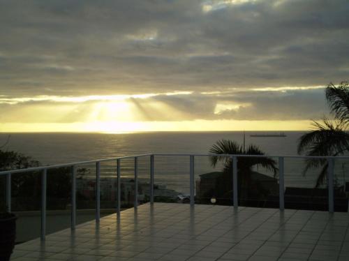 a view of the ocean from a balcony at The Homestead Margate - South Africa in Margate