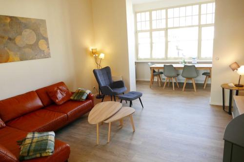 a living room with a couch and chairs and a table at Villa Inga & Anne in Ahlbeck