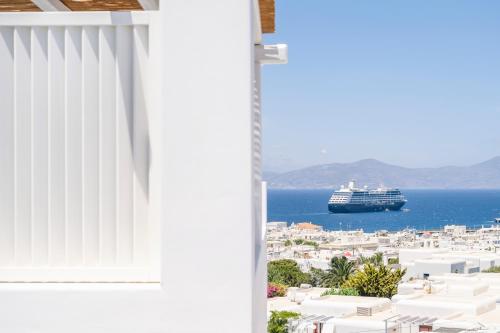 a cruise ship in the ocean viewed from a balcony at Rochari Hotel in Mýkonos City