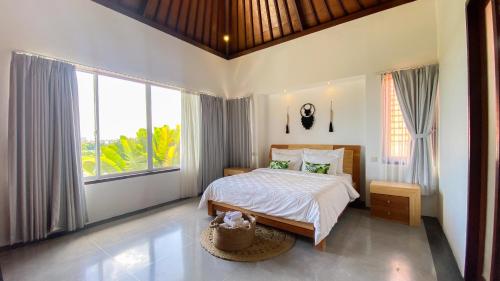 a bedroom with a bed and a large window at Villa Dew Canggu in Kerobokan