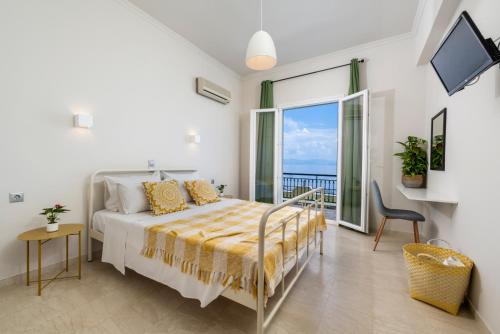 a bedroom with a bed with a view of the ocean at Batelo - Adults Only in Benitses