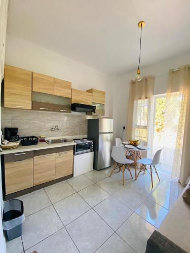 a kitchen with wooden cabinets and a table and chairs at Exanthia Sunset in Exanthia