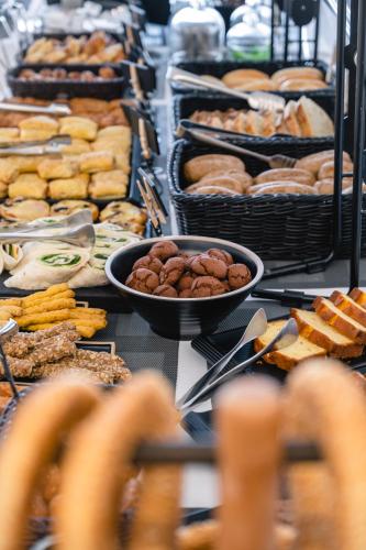 a buffet filled with lots of different types of food at Rochari Hotel in Mýkonos City
