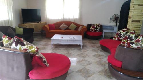 a living room with couches and a tv at الساحل الشمالي in Borg El Arab