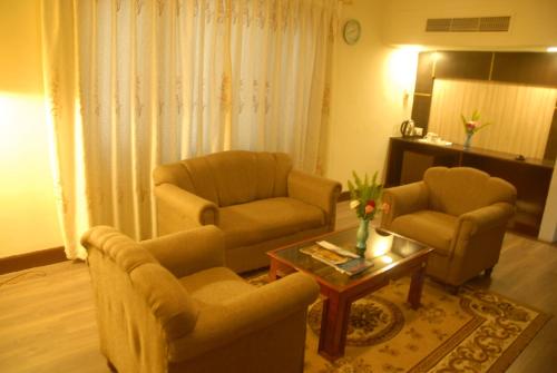 a living room with two chairs and a coffee table at Hotel Vaishali in Kathmandu