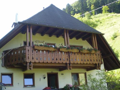 une maison avec un balcon au-dessus dans l'établissement Haus am Bach, à Fribourg-en-Brisgau