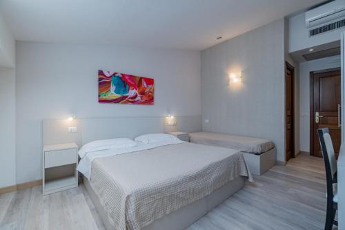 Ένα ή περισσότερα κρεβάτια σε δωμάτιο στο Hotel Bellavista