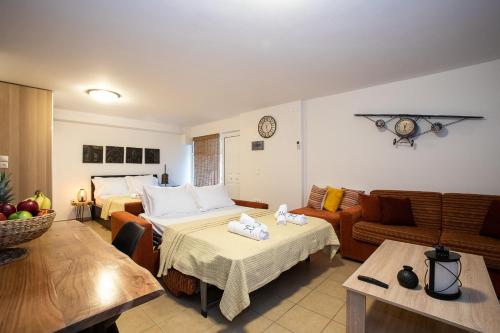 a living room with two beds and a couch at Villa Linda in Tolo