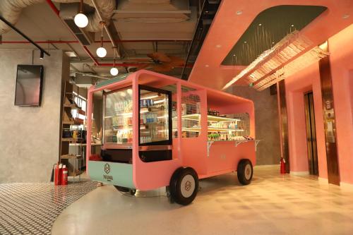 a small pink car parked in a room at HOME Hotel in Ho Chi Minh City