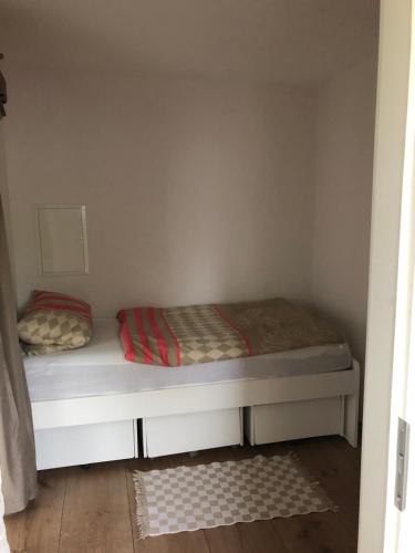 a bed in a small room with two pillows on it at Appartment Maggy in Bad Liebenwerda