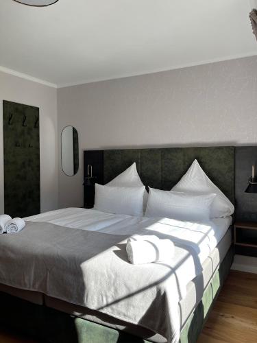 a bedroom with a large bed with white pillows at Schlosshotel Brilon-Wald in Brilon-Wald