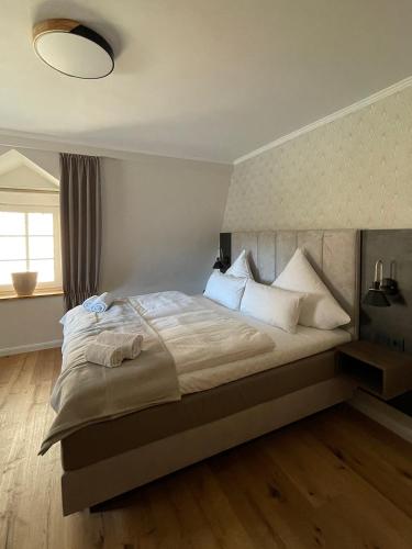a bedroom with a large bed with white pillows at Schlosshotel Brilon-Wald in Brilon-Wald