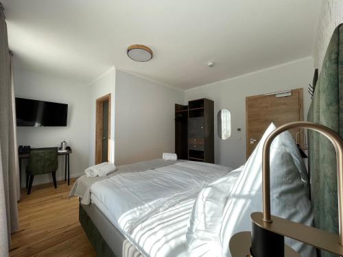 a bedroom with a bed and a desk at Schlosshotel Brilon-Wald in Brilon-Wald