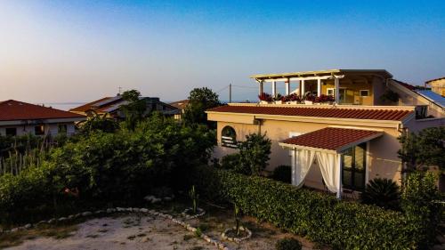 a house with a balcony on top of it at Michelino House in Parghelia