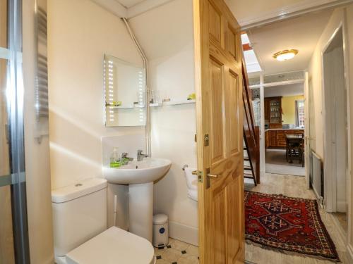 a bathroom with a toilet and a sink at Arch Cottage in Lincoln