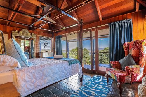 a bedroom with a bed and a large window at 1770 Sovereign Lodge Retreat in Seventeen Seventy