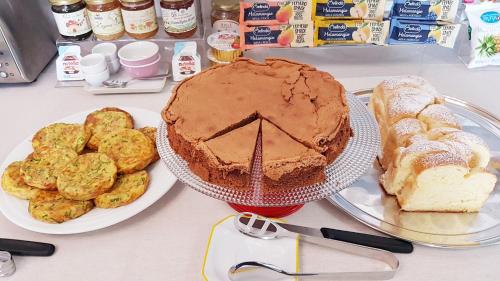 a table with a chocolate cake and some bread at Villa Bellavista Alba, B&B in Alba