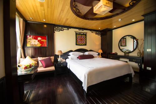 a bedroom with a large bed and a mirror at Dragon Legend Cruise in Ha Long