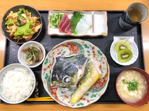 a tray of food with a plate of fish and rice at Housei in Zamami