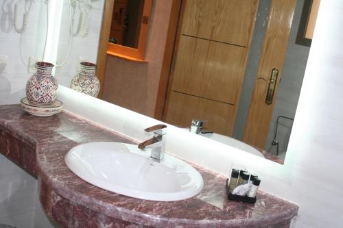 a bathroom with a sink and a mirror at Z Hotel Meknes in Meknès