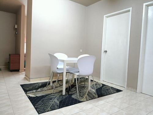 a white table and chairs in a room at Homestay Wafiy Lost World Tambun Ipoh in Ipoh