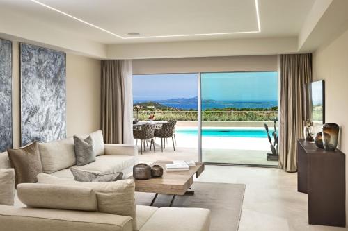 a living room with a couch and a table at Hotel Li Finistreddi in Cannigione