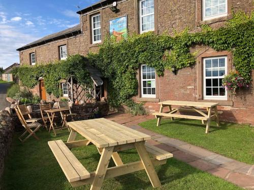 a picnic table in front of a building at Kitty’s Place, Apartment, Eden Valley, Cumbria in Brampton