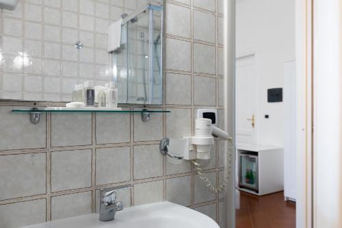 a bathroom with a sink and a mirror at Rex Lifestyle Hotel in Naples