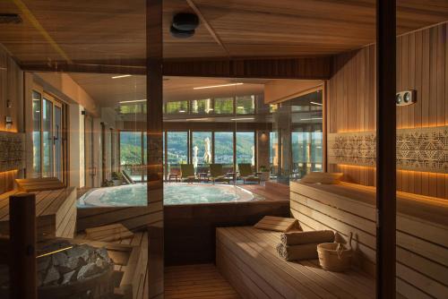 a large room with a jacuzzi tub in a house at Wine & SPA Hotel Chukara in Tryavna