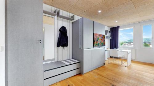 a living room with a hallway with a window at Evi's Home Hotel & Apartments in Bern