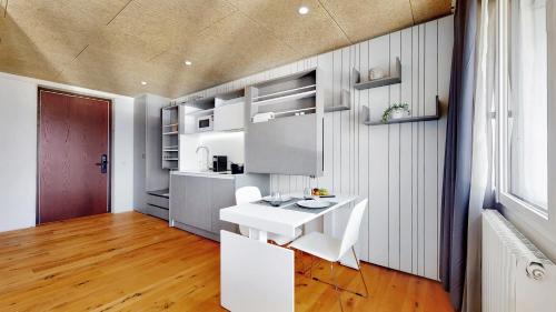 a kitchen with a white sink and a counter at Evi's Home Hotel & Apartments in Bern