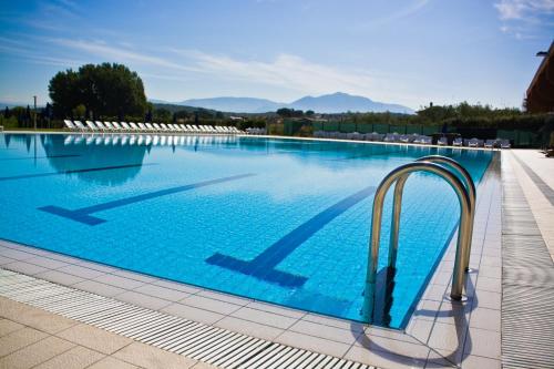 a large swimming pool with blue water at Life Sport Hotel in Mentana