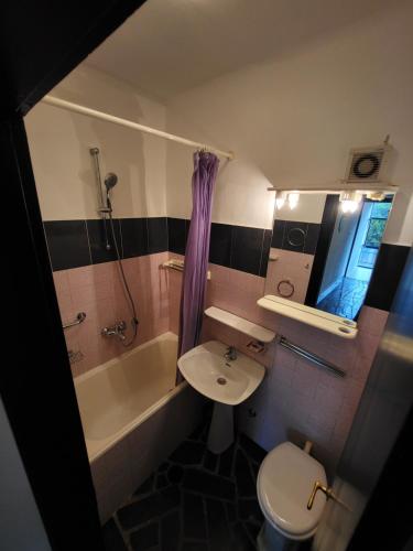 a bathroom with a sink and a toilet and a tub at Apartment Dubrovnik Surprise in Dubrovnik