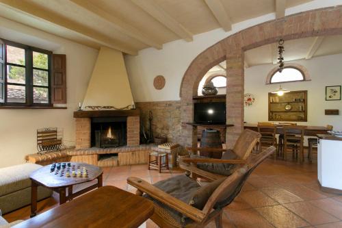 a living room filled with furniture and a fireplace at Agriturismo Poggio Salvi in Sovicille
