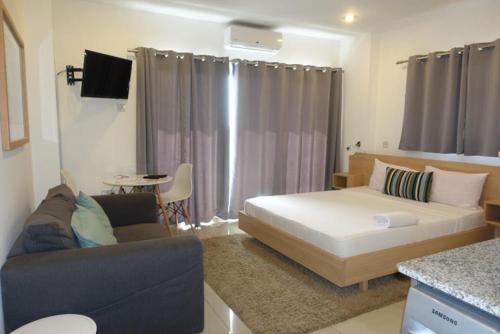 a living room with a bed and a couch at The Gallery Luxury Apartments in Accra