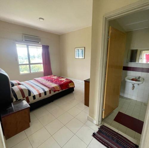 a bedroom with a bed and a bathroom with a shower at Fullhouse Marina View Villas Apartment in Port Dickson