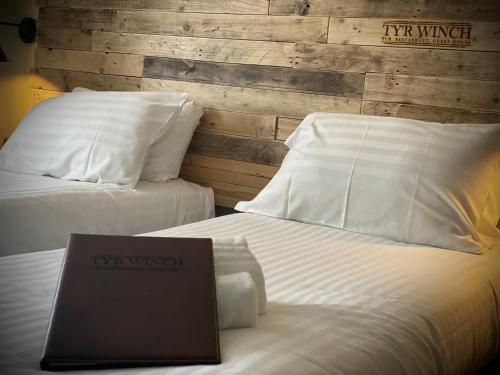a laptop computer sitting on top of two beds at Tyr Winch in Cardiff