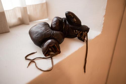 a statue of a boxing glove on a wall at Parkhotel Mondschein, a Member of Design Hotels in Bolzano