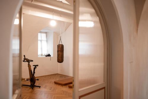 an arched doorway to a room with a treadmill at Parkhotel Mondschein, a Member of Design Hotels in Bolzano