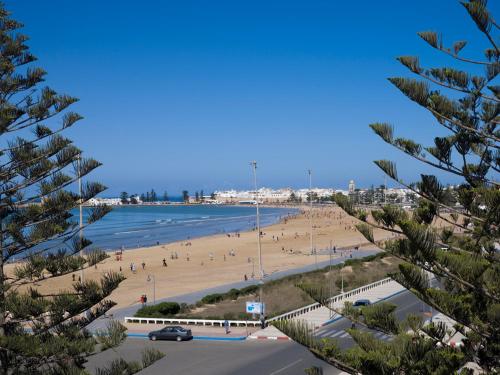 a view of a beach with people in the water at Atlas Essaouira Riad Resort in Essaouira