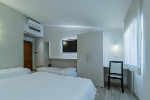 Ένα ή περισσότερα κρεβάτια σε δωμάτιο στο Hotel Bellavista
