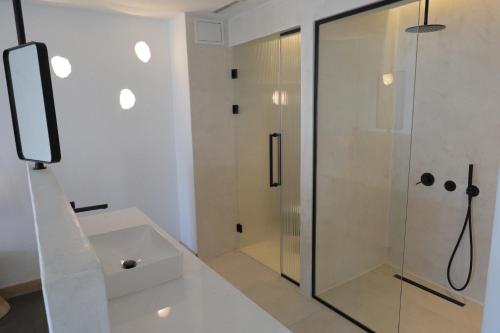 a bathroom with a shower and a sink at Kalkan Han Hotel in Kalkan