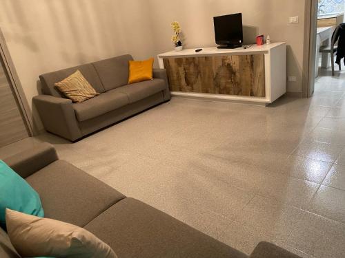 a living room with a couch and a flat screen tv at Coco' Country House Lecce in Lecce