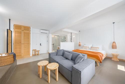 a living room with a couch and a bed at Kalkan Han Hotel in Kalkan