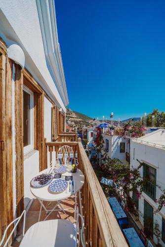 a balcony with two tables and a view of the ocean at Kalkan Han Hotel in Kalkan