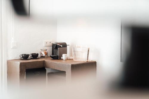 a kitchen with a counter with a coffee maker at Kalkan Han Hotel in Kalkan