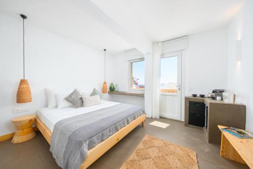 a bedroom with a bed and a large window at Kalkan Han Hotel in Kalkan