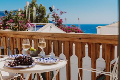a table on a balcony with two glasses of wine at Kalkan Han Hotel in Kalkan